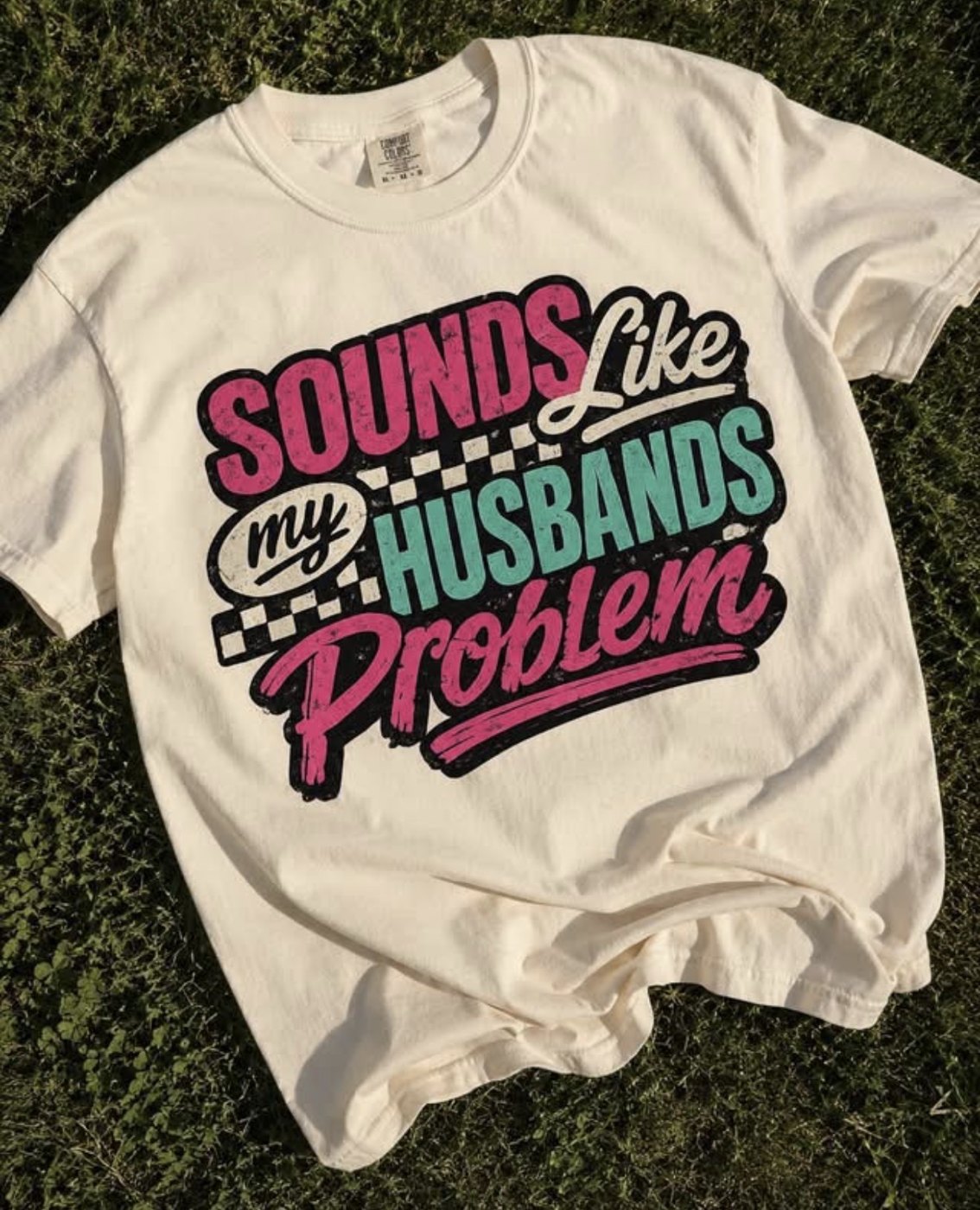 Cream t-shirt with a bold pink and teal custom graphic design